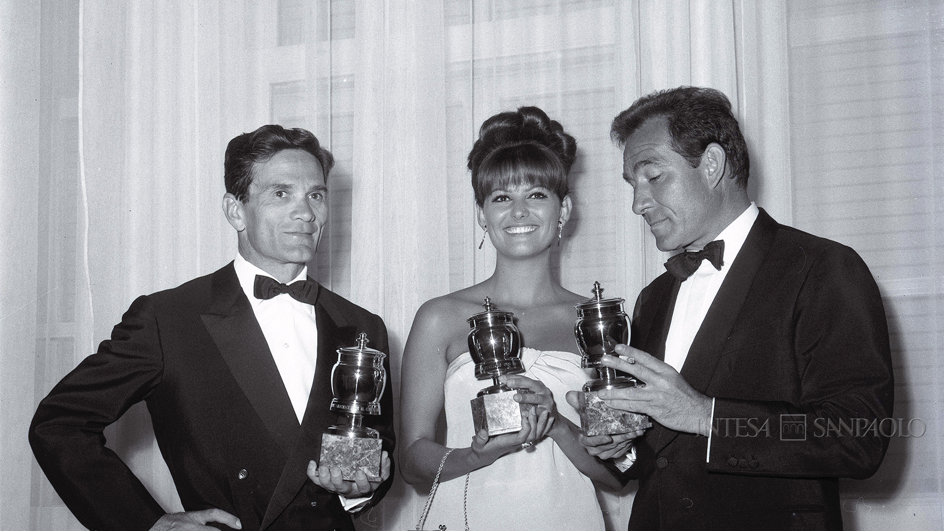 Intesa Sanpaolo Publifoto Archive Pier Paolo Pasolini, Claudia Cardinale and Ugo Tognazzi awarded the Grolle d'oro for Best Director, Best Actress and Best Actor respectively, at the 12th Saint Vincent Grand Prize for Cinema on 4 July 1964 (photograph by Danilo Pajola)
