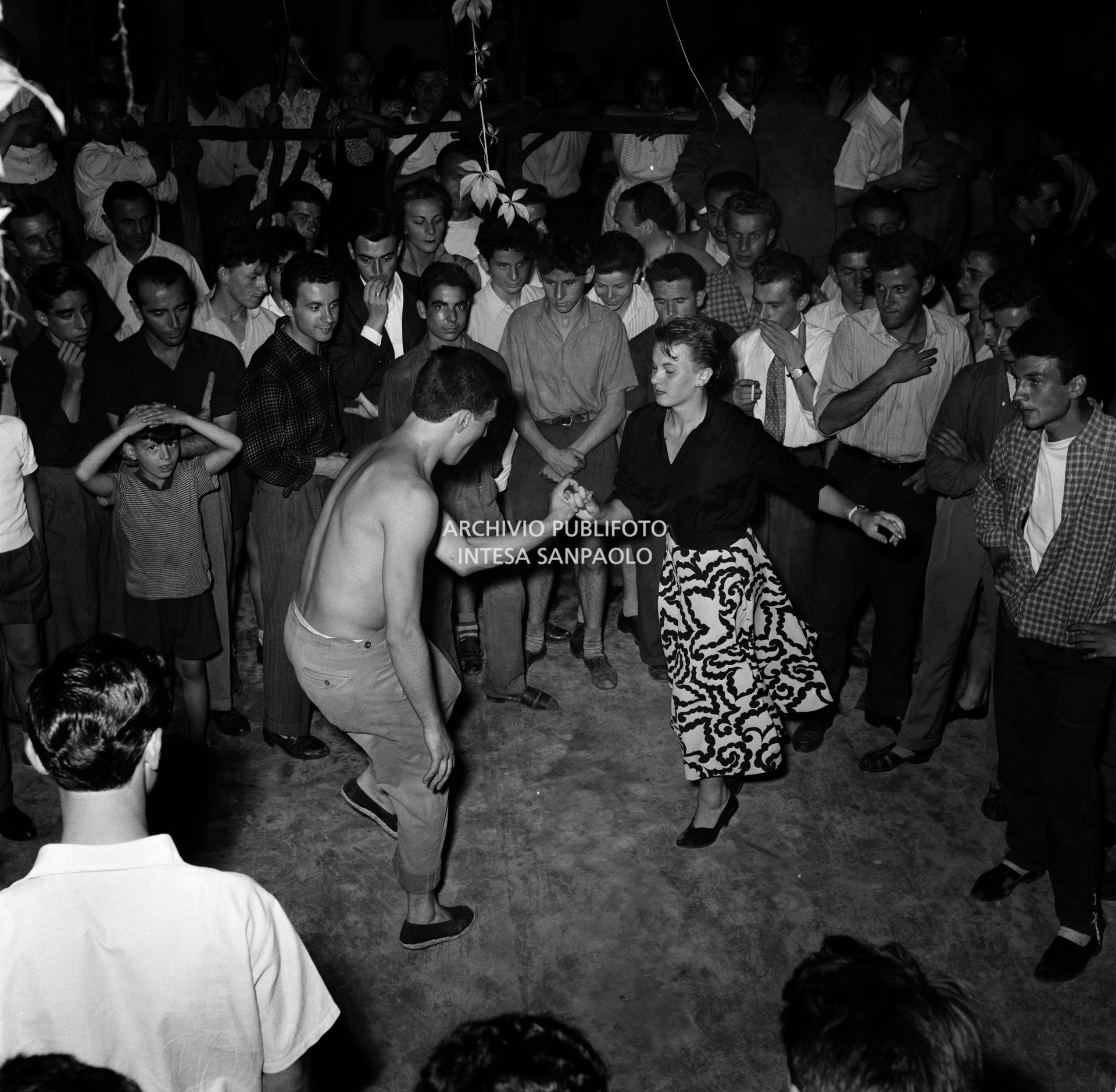 Two teenagers dancing in a club on the outskirts of Milan