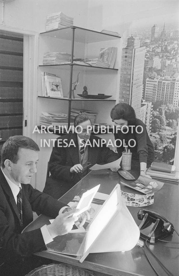 Nick Giordano (foreground), Anna Petrelli and a customer of the Publifoto Agency in Milan