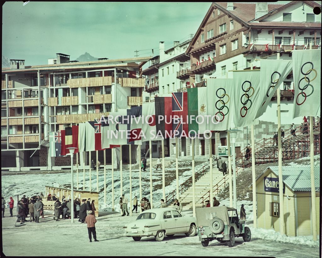 Flags of various countries and of the five Olympic rings on display in Cortina d'Ampezzo to mark the 7th Winter Olympic Games