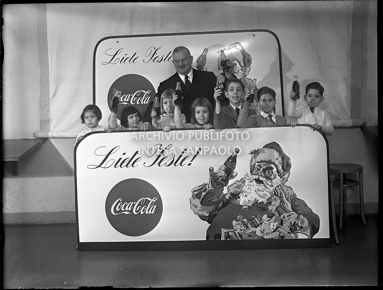 A Coca-Cola manager with a group of children on the advertising campaign set in Milan