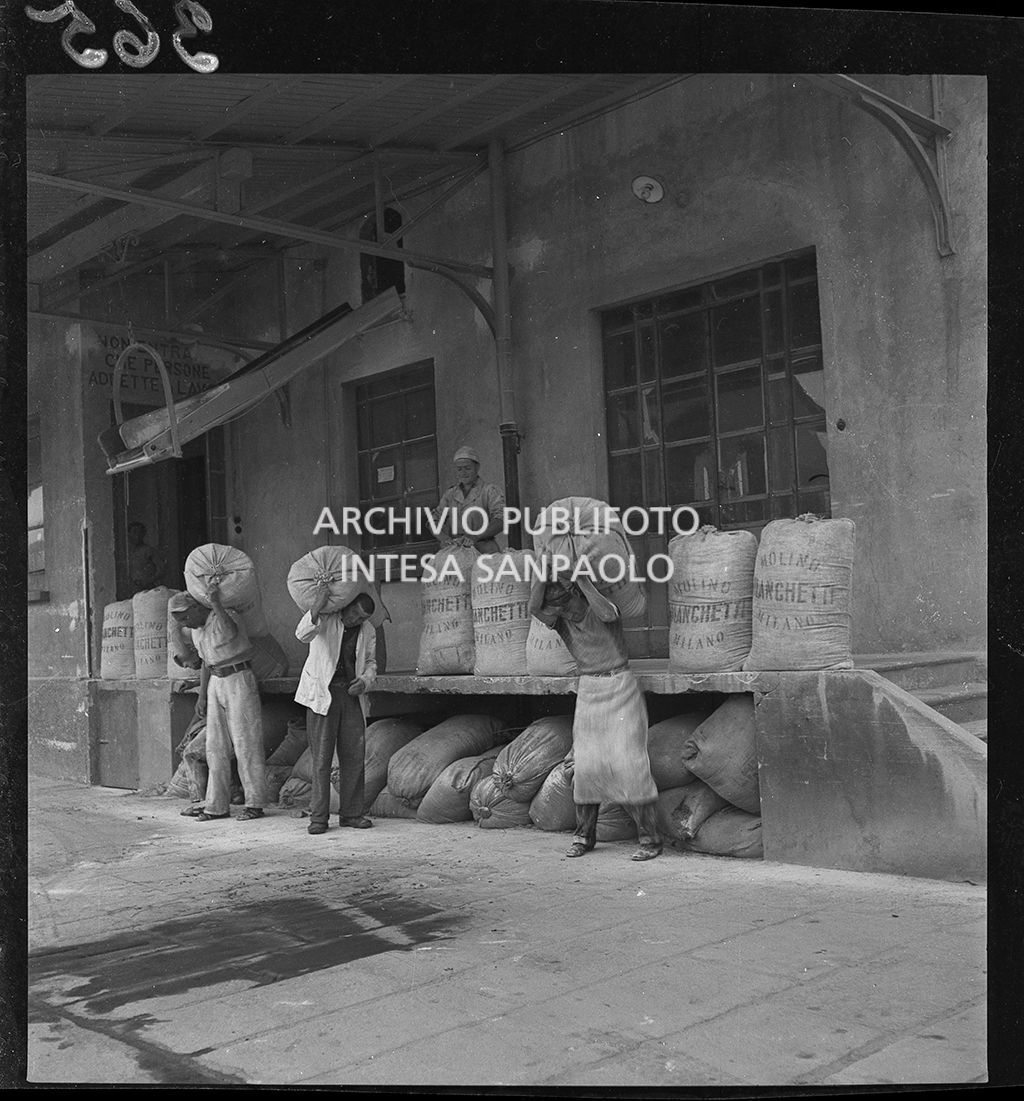 Unloading of flour sacks, sent by Allied Forces to help the local population