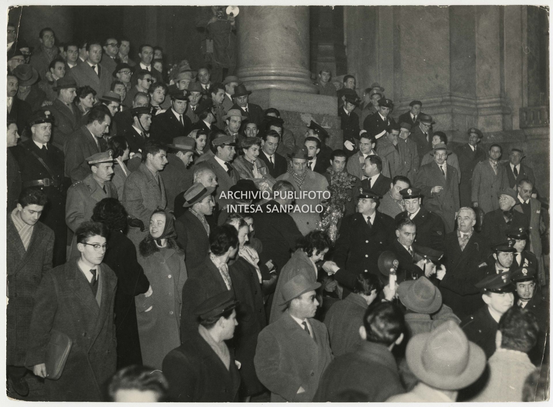 Crowd at Milan's Stazione Centrale welcomes Maria Callas on her return from the interrupted "Première" at the Teatro dell'Opera in Rome.