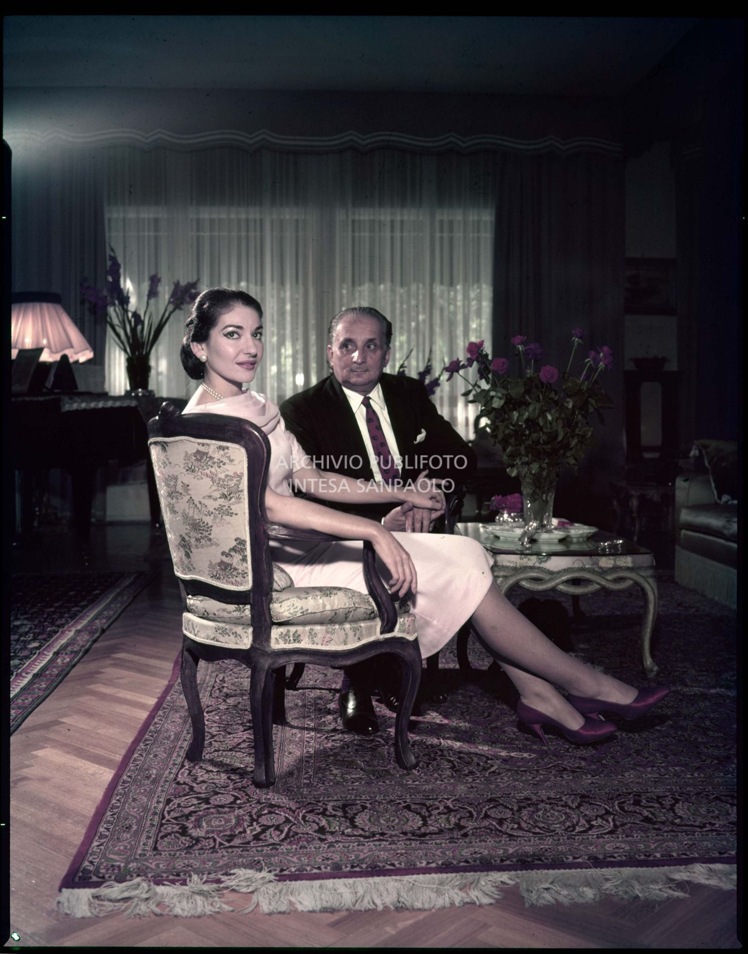 Maria Callas and her husband Giovanni Battista Meneghini posing in the living room