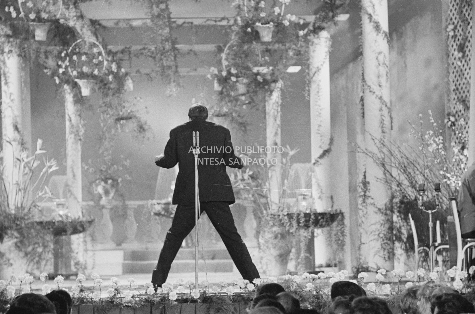 Adriano Celentano turns his back on the audience during his performance at the 11th Sanremo Festival, where he sang "24.000 baci"