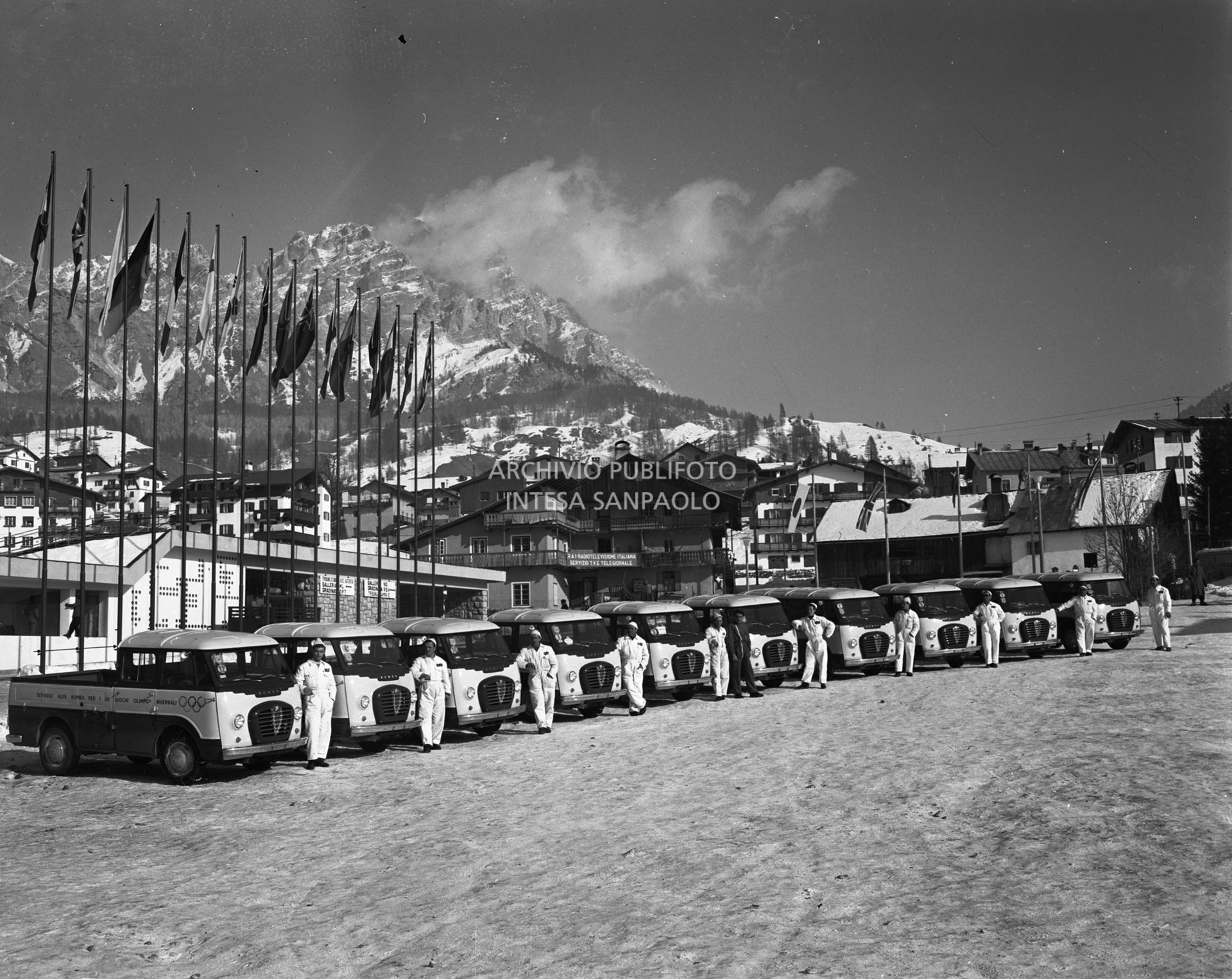 Alfa Romeo vans with drivers, at the disposal of participants in the 7th Winter Olympic Games, lined up in front of the Ice Stadium