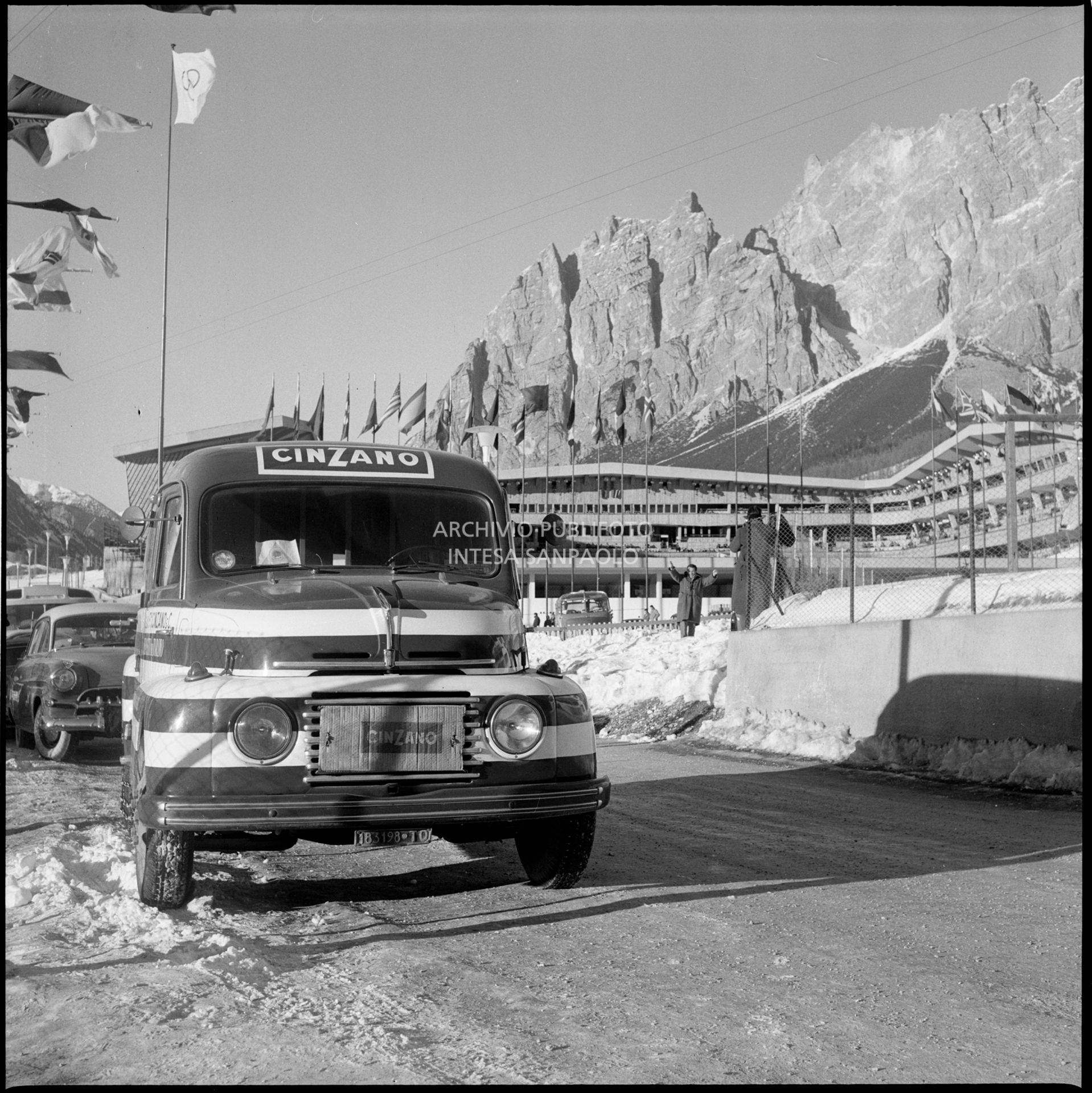 Truck advertising Cinzano; the Ice Stadium in the background