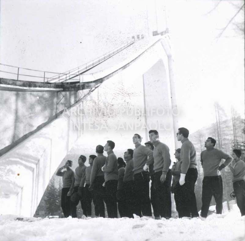 Athletes at the base of the Trampolino Italia ski jump