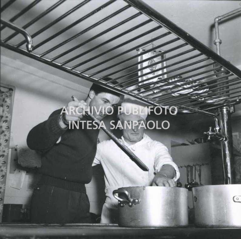 Downhill skier Toni Sailer in a restaurant kitchen with the chef
